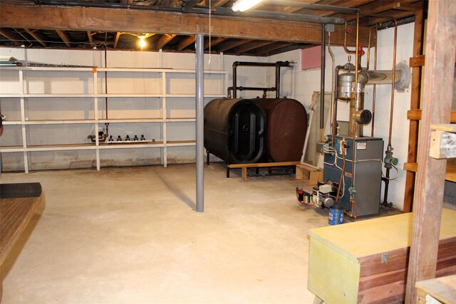 113 Pine Neck Ave, East Patchogue, NY 11772 - unfinished basement featuring a heating unit and oil tank