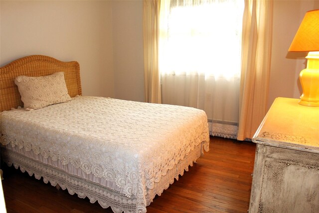 113 Pine Neck Ave, East Patchogue, NY 11772 - bedroom with multiple windows and dark wood finished floors