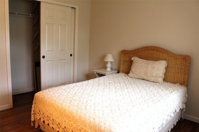 113 Pine Neck Ave, East Patchogue, NY 11772 - bedroom with a closet, dark wood-style floors, and baseboards