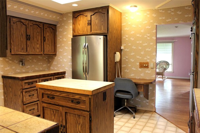 113 Pine Neck Ave, East Patchogue, NY 11772 - kitchen featuring freestanding refrigerator, wallpapered walls, crown molding, light flooring, and an office area