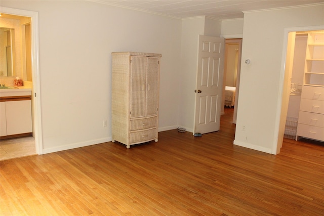 113 Pine Neck Ave, East Patchogue, NY 11772 - unfurnished bedroom featuring ornamental molding, light wood-type flooring, baseboards, and ensuite bath