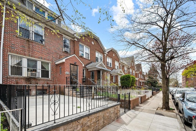 34-15 91st St, Jackson Heights, NY 11372 - townhome / multi-family property featuring a residential view, a fenced front yard, and brick siding