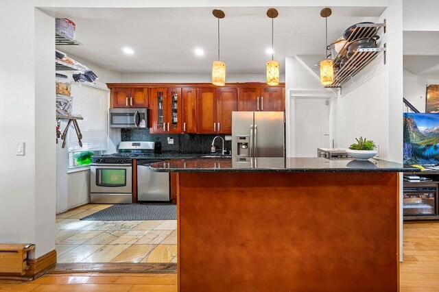 34-15 91st St, Jackson Heights, NY 11372 - kitchen featuring appliances with stainless steel finishes, a center island, backsplash, a sink, and pendant lighting
