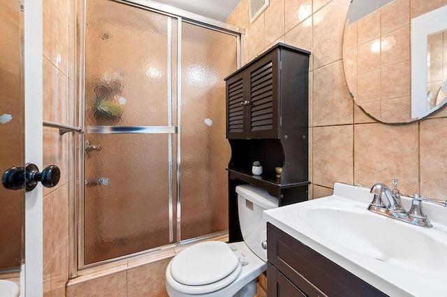 34-15 91st St, Jackson Heights, NY 11372 - bathroom with tile walls, toilet, a stall shower, and vanity