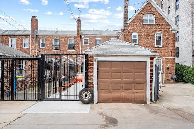 34-15 91st St, Jackson Heights, NY 11372 - multi unit property featuring a gate, brick siding, an attached garage, and driveway