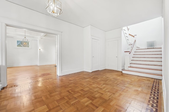 158 Loring Ave, Pelham, NY 10803 - unfurnished living room featuring stairs, a chandelier, and baseboards