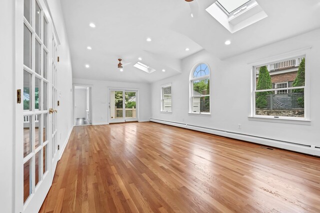 158 Loring Ave, Pelham, NY 10803 - unfurnished room with a skylight, wood finished floors, a baseboard heating unit, lofted ceiling, and recessed lighting