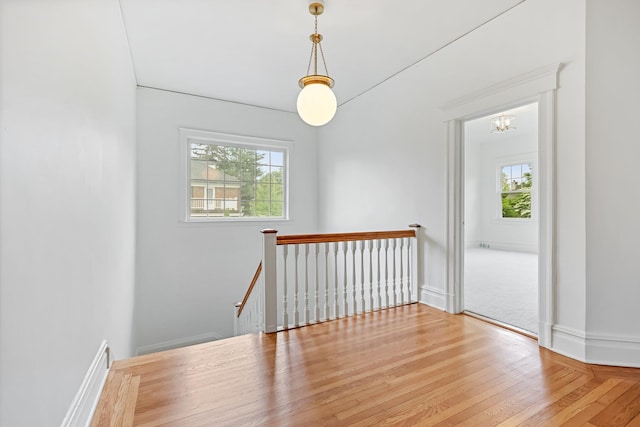 158 Loring Ave, Pelham, NY 10803 - empty room with a chandelier, wood finished floors, and baseboards