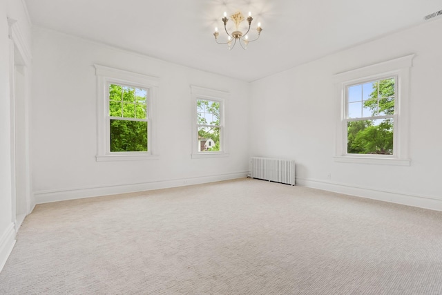 158 Loring Ave, Pelham, NY 10803 - unfurnished room featuring radiator heating unit, healthy amount of natural light, a chandelier, and carpet floors