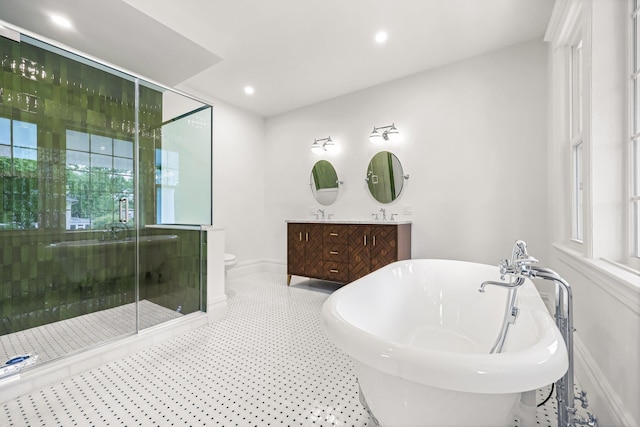 158 Loring Ave, Pelham, NY 10803 - bathroom with double vanity, baseboards, a stall shower, a freestanding tub, and toilet