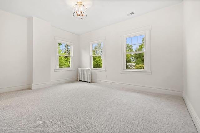 158 Loring Ave, Pelham, NY 10803 - empty room featuring radiator, carpet, a chandelier, and baseboards