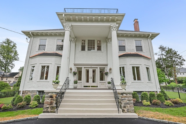 158 Loring Ave, Pelham, NY 10803 - view of front of house with french doors, a chimney, and stucco siding