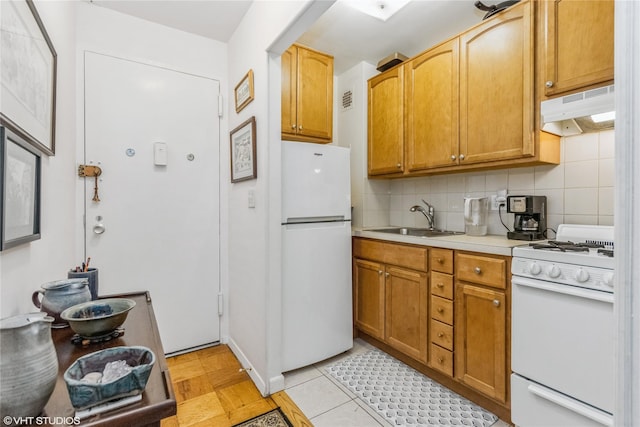 35 Stewart Pl Unit 302, Mount Kisco, NY 10549 - kitchen with white appliances, under cabinet range hood, a sink, light countertops, and backsplash