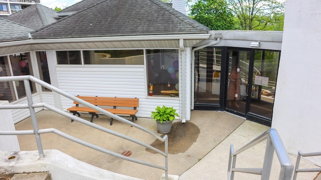 200 High Point Dr Unit 302, Hartsdale, NY 10530 - entrance to property with a shingled roof and a patio area