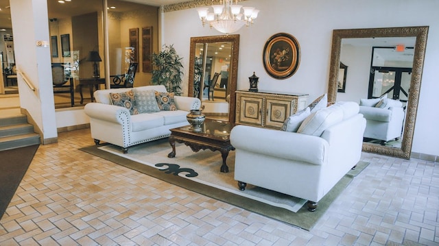 200 High Point Dr Unit 302, Hartsdale, NY 10530 - living room with a chandelier, brick patterned floors, and baseboards