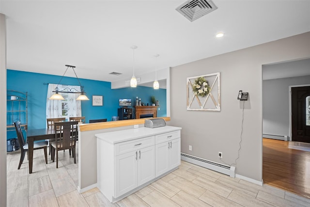 7 Pilgrim Ln, Washingtonville, NY 10992 - kitchen featuring a baseboard radiator, white cabinetry, wood tiled floors, hanging light fixtures, and recessed lighting