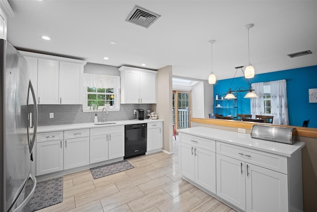 7 Pilgrim Ln, Washingtonville, NY 10992 - kitchen featuring dishwasher, stainless steel fridge, a sink, tasteful backsplash, and light countertops
