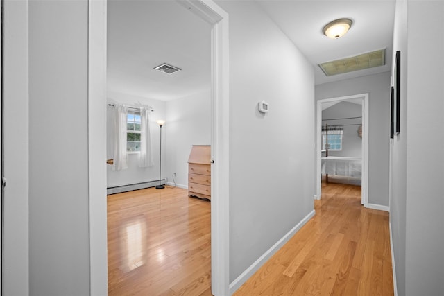 7 Pilgrim Ln, Washingtonville, NY 10992 - corridor featuring a baseboard radiator, light wood-style floors, and baseboards