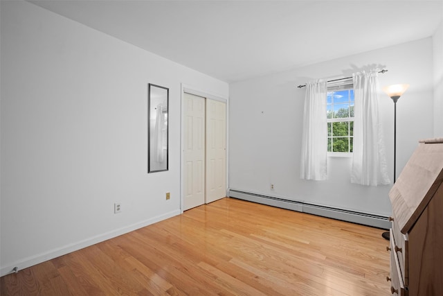 7 Pilgrim Ln, Washingtonville, NY 10992 - unfurnished bedroom with a baseboard radiator, light wood finished floors, baseboards, and a closet