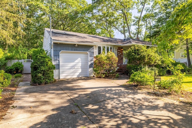 810 Tooker Ave, West Babylon, NY 11704 - view of front of home featuring driveway, a garage, a shingled roof, and brick siding