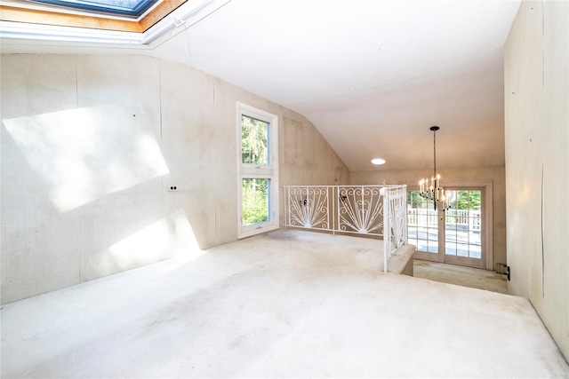 810 Tooker Ave, West Babylon, NY 11704 - carpeted empty room with vaulted ceiling, a chandelier, healthy amount of natural light, and a skylight
