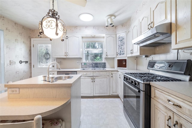 810 Tooker Ave, West Babylon, NY 11704 - kitchen featuring stainless steel range with gas stovetop, under cabinet range hood, wallpapered walls, light countertops, and pendant lighting