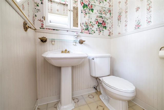 810 Tooker Ave, West Babylon, NY 11704 - half bathroom with wallpapered walls and a wainscoted wall