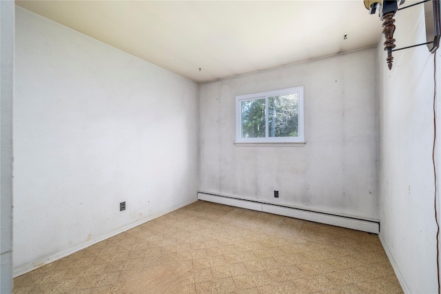 810 Tooker Ave, West Babylon, NY 11704 - empty room with baseboard heating and tile patterned floors