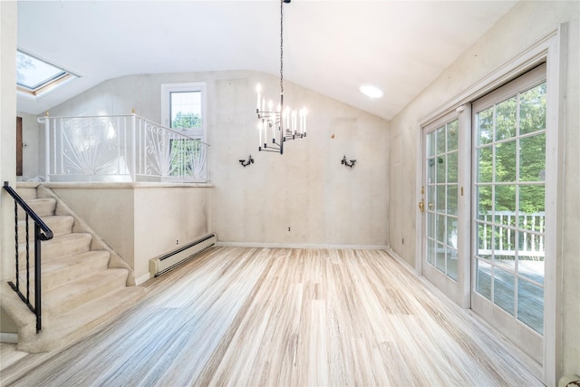 810 Tooker Ave, West Babylon, NY 11704 - unfurnished dining area featuring vaulted ceiling, a baseboard radiator, a skylight, stairs, and wood finished floors