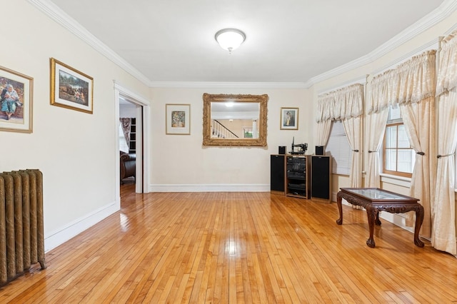 57 Maple Ave, Bay Shore, NY 11706 - sitting room featuring radiator, ornamental molding, light wood finished floors, and baseboards