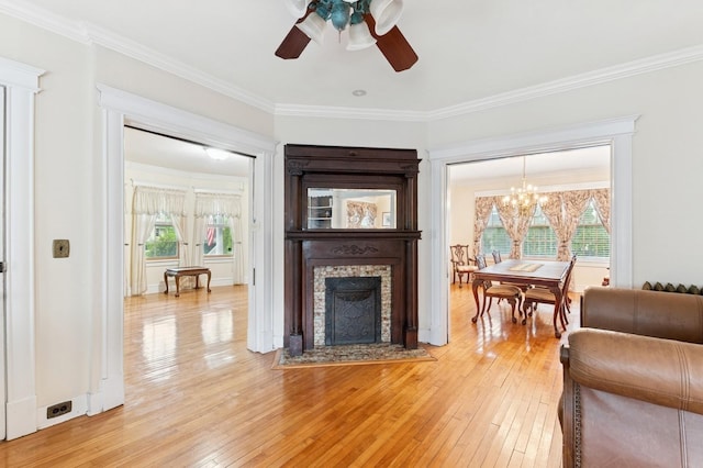 57 Maple Ave, Bay Shore, NY 11706 - living room featuring a ceiling fan, light wood-style flooring, ornamental molding, a chandelier, and a fireplace with flush hearth