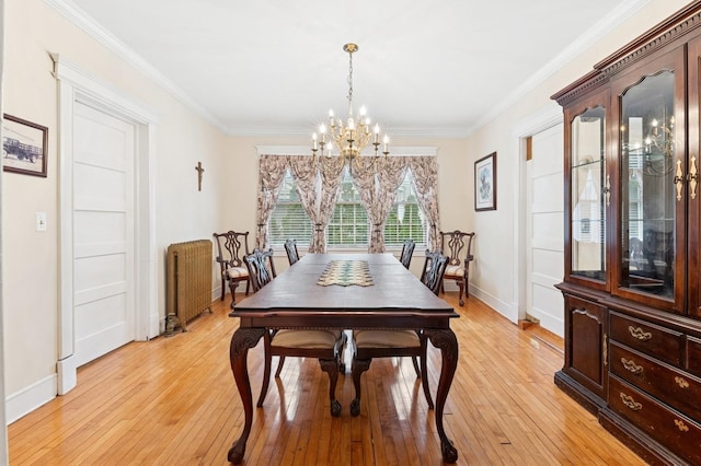 57 Maple Ave, Bay Shore, NY 11706 - dining area with a chandelier, radiator, ornamental molding, light wood finished floors, and baseboards