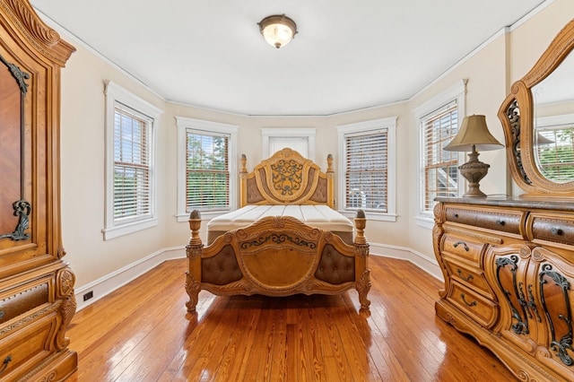 57 Maple Ave, Bay Shore, NY 11706 - bedroom with multiple windows, light wood-style floors, baseboards, and ornamental molding