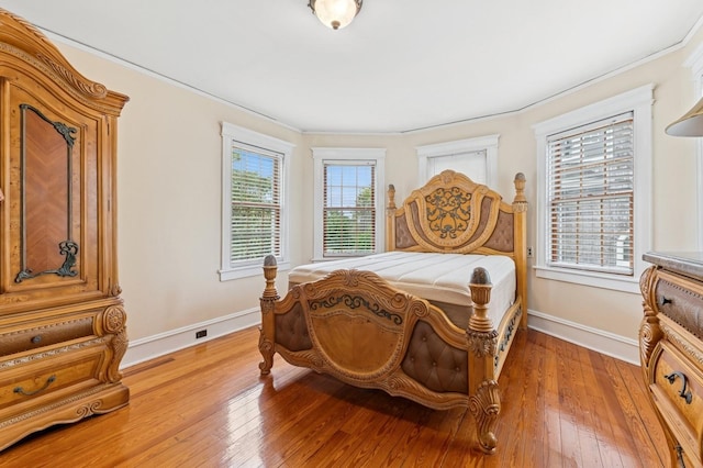 57 Maple Ave, Bay Shore, NY 11706 - bedroom with baseboards, light wood finished floors, and crown molding