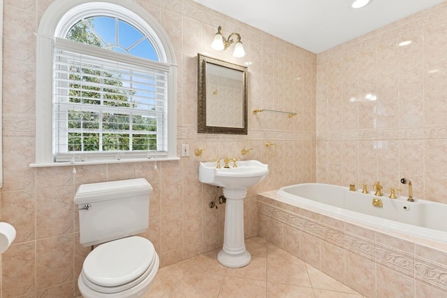 57 Maple Ave, Bay Shore, NY 11706 - full bathroom with plenty of natural light, tile walls, tiled tub, tile patterned floors, and toilet