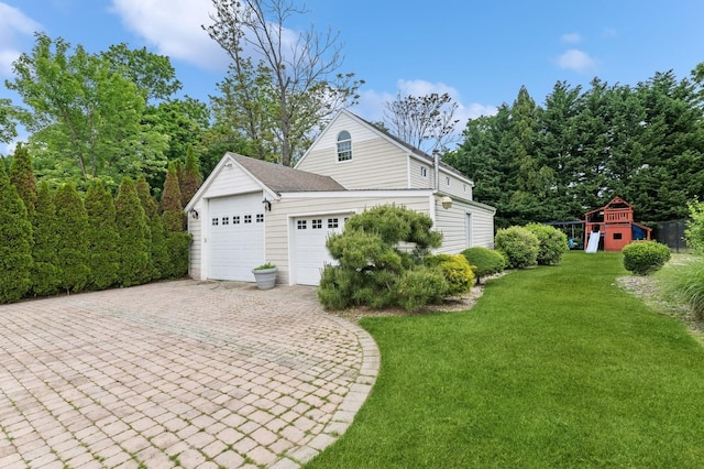 57 Maple Ave, Bay Shore, NY 11706 - view of side of home with a garage, a playground, driveway, and a yard