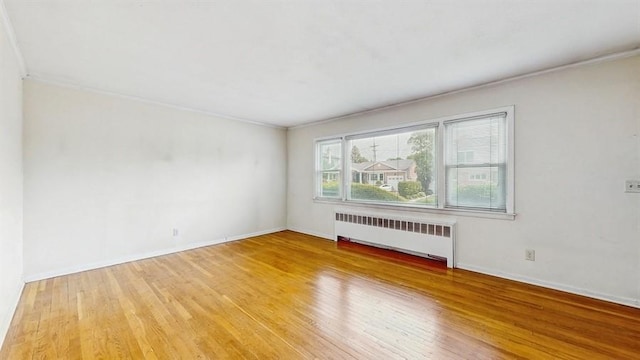 29 Melanie Ln, Syosset, NY 11791 - spare room featuring radiator, wood finished floors, crown molding, and baseboards
