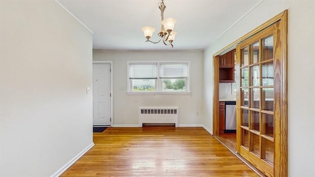 29 Melanie Ln, Syosset, NY 11791 - unfurnished dining area with radiator, ornamental molding, a chandelier, light wood-type flooring, and baseboards