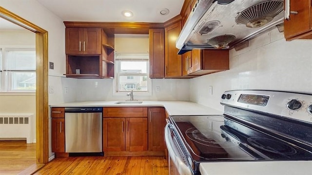 29 Melanie Ln, Syosset, NY 11791 - kitchen featuring stainless steel appliances, radiator, custom range hood, a sink, and light countertops