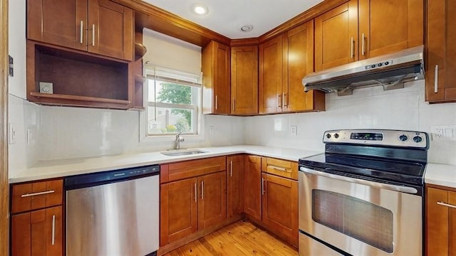29 Melanie Ln, Syosset, NY 11791 - kitchen featuring stainless steel appliances, under cabinet range hood, a sink, light wood-type flooring, and light countertops