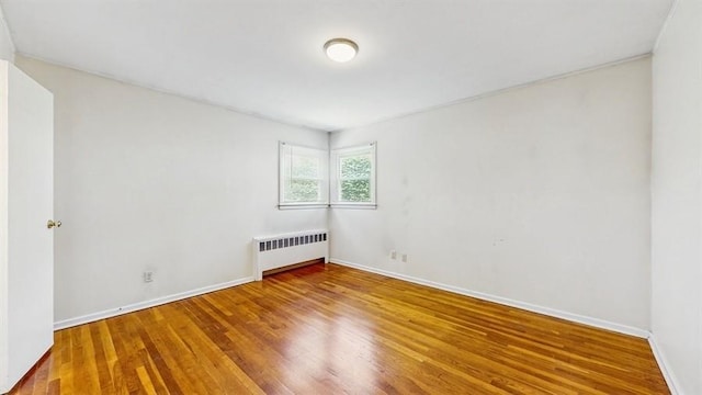 29 Melanie Ln, Syosset, NY 11791 - spare room featuring radiator, wood finished floors, and baseboards
