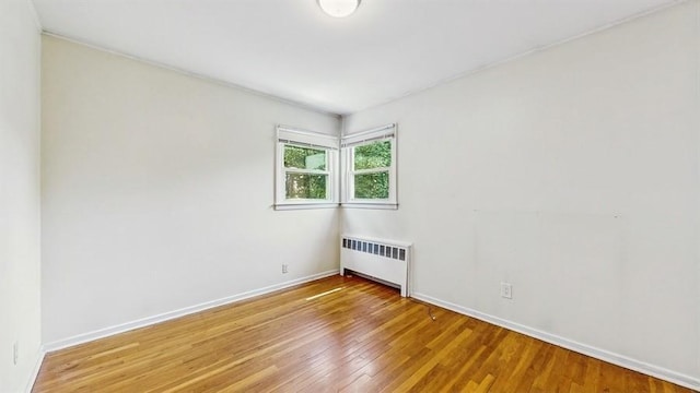 29 Melanie Ln, Syosset, NY 11791 - unfurnished room with radiator heating unit, wood finished floors, and baseboards