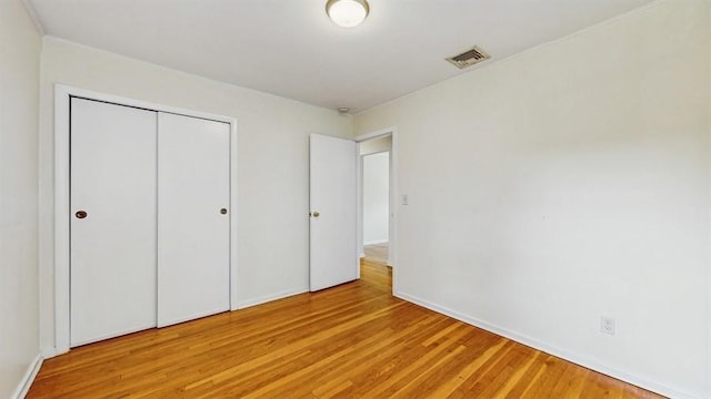 29 Melanie Ln, Syosset, NY 11791 - unfurnished bedroom featuring light wood-style floors, a closet, and baseboards