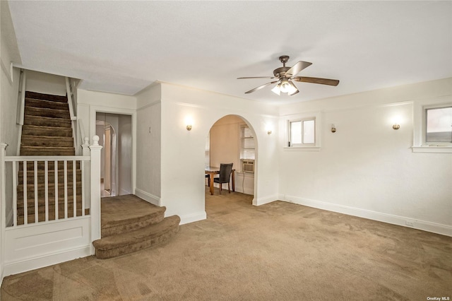 53-42 63rd St, Maspeth, NY 11378 - empty room with arched walkways, carpet, stairway, a ceiling fan, and baseboards