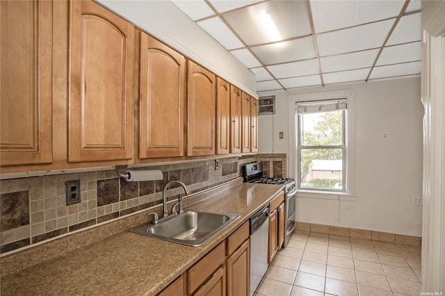 53-42 63rd St, Maspeth, NY 11378 - kitchen with a sink, appliances with stainless steel finishes, decorative backsplash, brown cabinetry, and light tile patterned floors