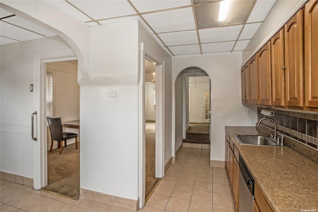 53-42 63rd St, Maspeth, NY 11378 - kitchen with a sink, arched walkways, stainless steel dishwasher, light tile patterned flooring, and tasteful backsplash