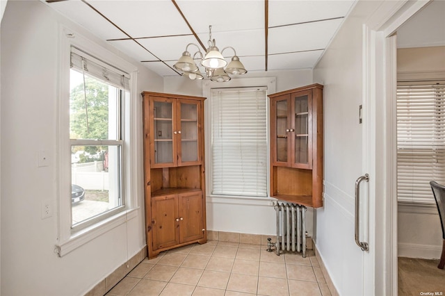 53-42 63rd St, Maspeth, NY 11378 - dining room with radiator heating unit, a chandelier, light tile patterned flooring, baseboards, and a drop ceiling