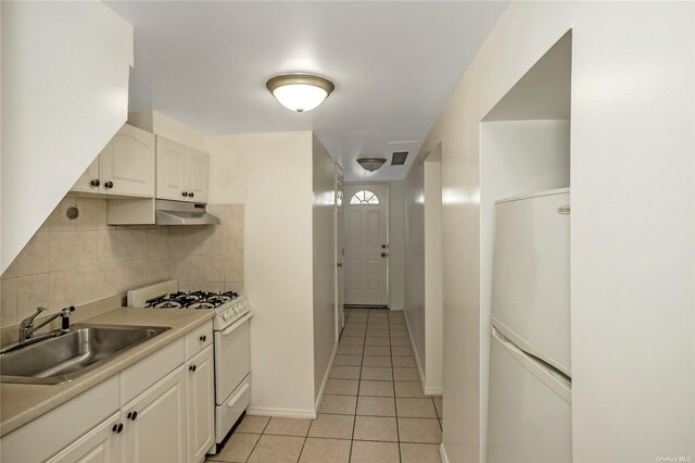 53-42 63rd St, Maspeth, NY 11378 - kitchen featuring white appliances, a sink, under cabinet range hood, light tile patterned flooring, and decorative backsplash