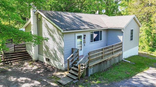287 Norton Rd, Red Hook, NY 12571 - view of front facade with stairway, a chimney, a shingled roof, and a deck