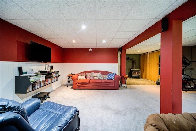 287 Norton Rd, Red Hook, NY 12571 - carpeted living area featuring a drop ceiling, recessed lighting, a wainscoted wall, and a wood stove